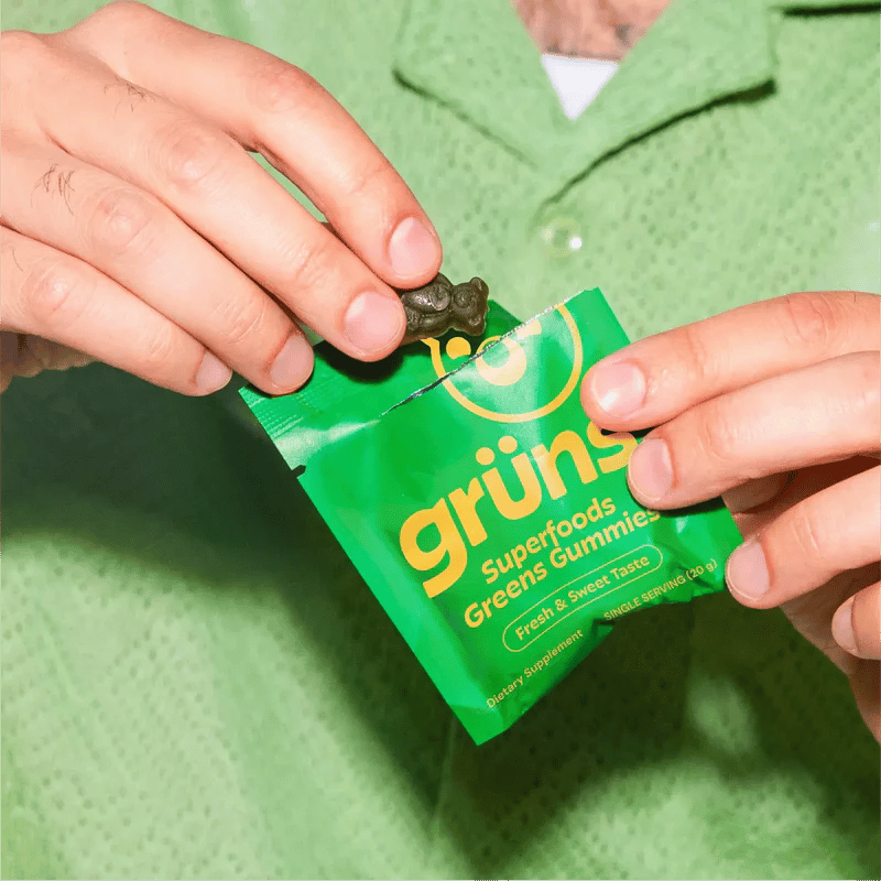 Hands opening a Grüns daily snack pack